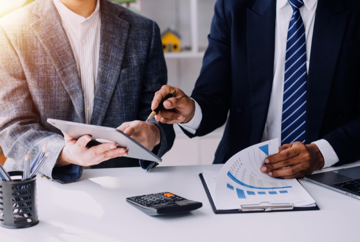 Deux conseillers financiers analysant des graphiques et tableaux de performance